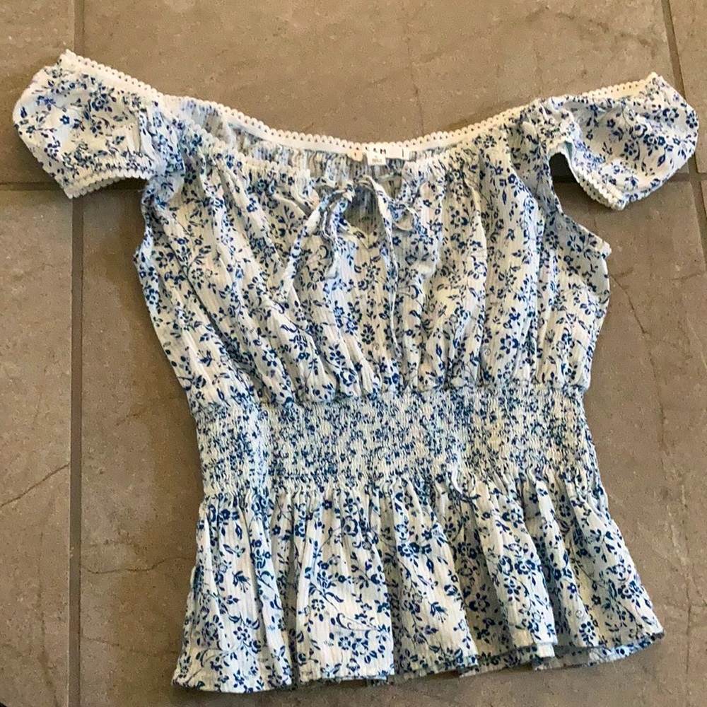 A blue and white floral off the shoulder shirt
